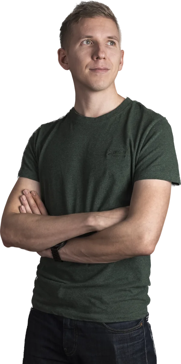 Tapio Kauranen looking up thoughtfully with his arms crossed, in a green T-shirt
