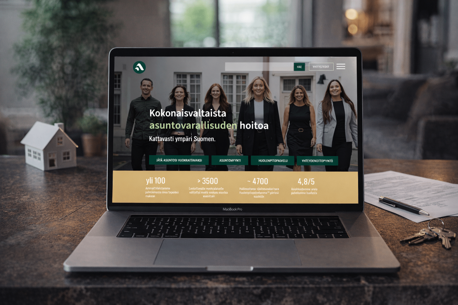 Asuntopehtoori's website on a laptop: six smiling people and the headline “Kokonaisvaltaista asuntovarallisuuden hoitoa” (comprehensive management of residential property)