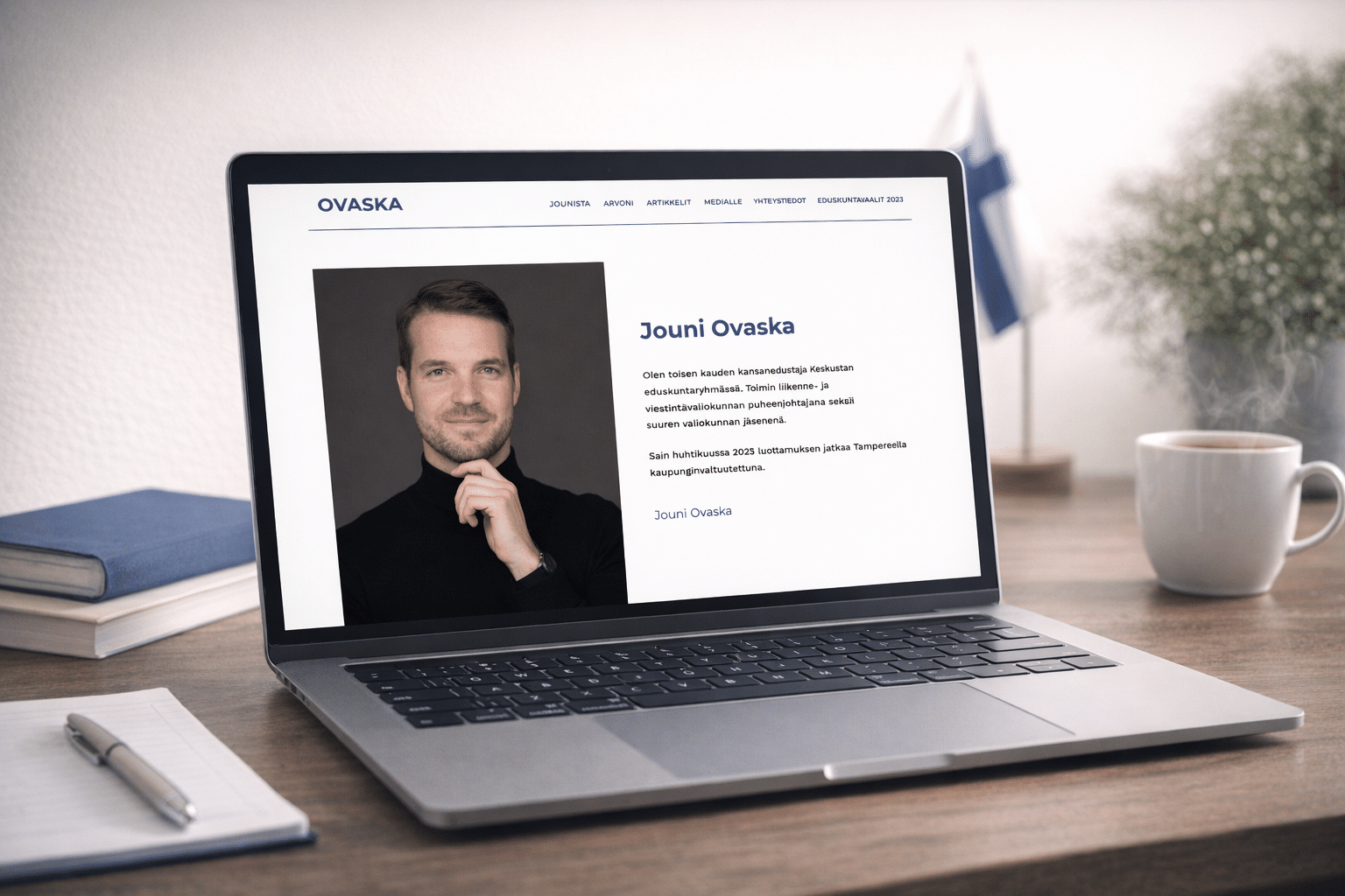 Jouni Ovaska's website on a laptop: a photo of the Member of Parliament and an introduction, with the Finnish flag behind