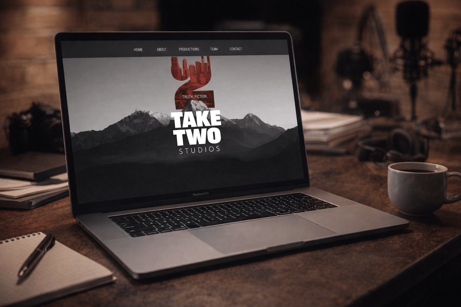 Take Two Studios' website on a laptop: the logo over a mountain landscape, with a camera and a microphone in the background
