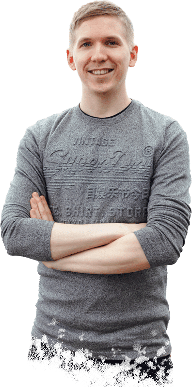 Tapio Kauranen smiling with his arms crossed, in a grey long-sleeved shirt