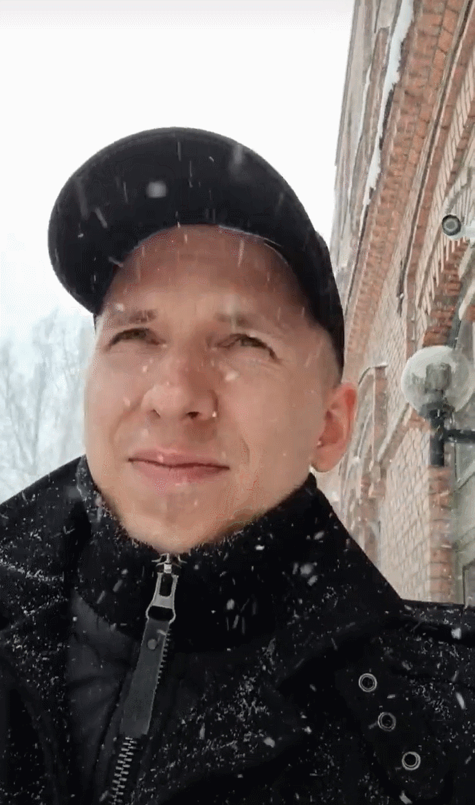 Tapio Kauranen standing in heavy snowfall in a black cap and a winter coat